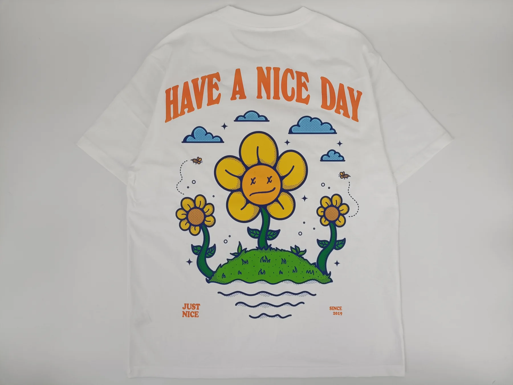 Multicolor artwork on a white T-shirt sample: compare detail, coverage and surface feel on the actual garment.