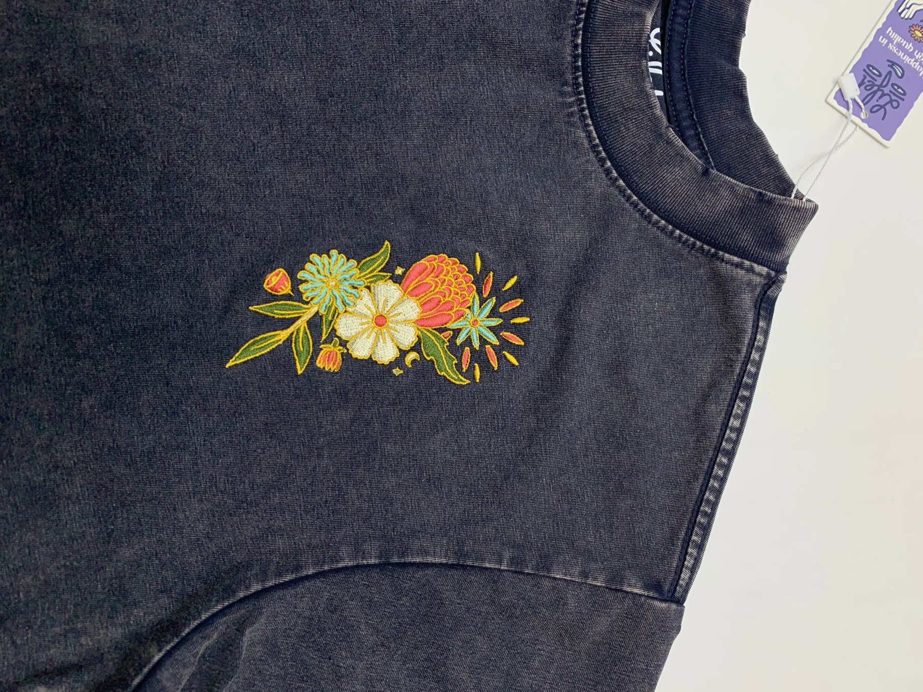 Floral embroidery beside a neckline: specify both decoration placement and garment construction in the tech pack.